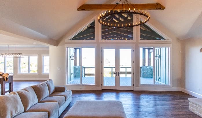 a frame living room with large windows and custom lighting